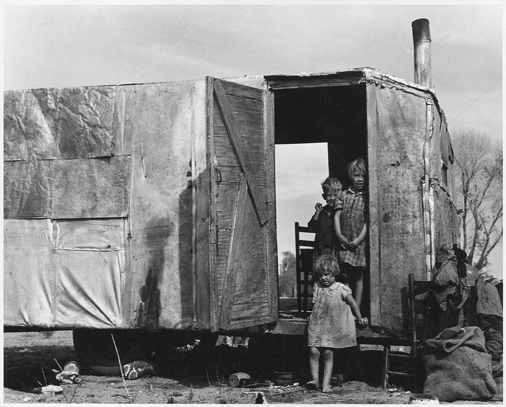 A migratory family from Texas living in a trailer in an open field